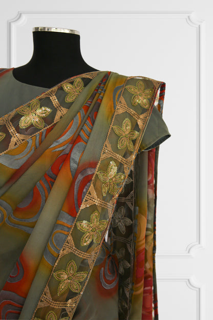 Olive Green Saree with Vibrant Swirls and Embroidered Gold Border