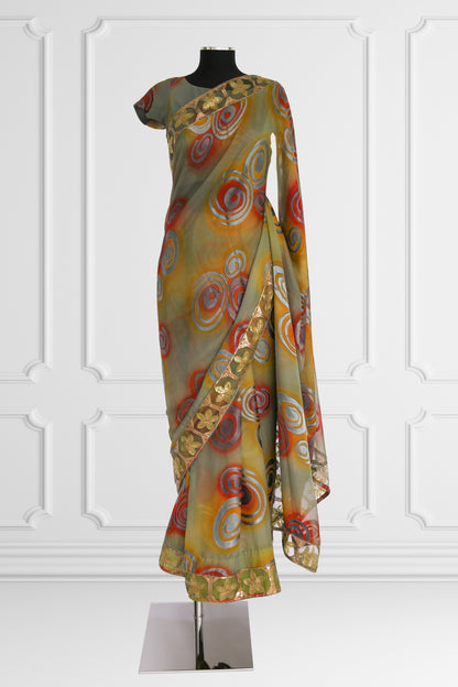 Olive Green Saree with Vibrant Swirls and Embroidered Gold Border